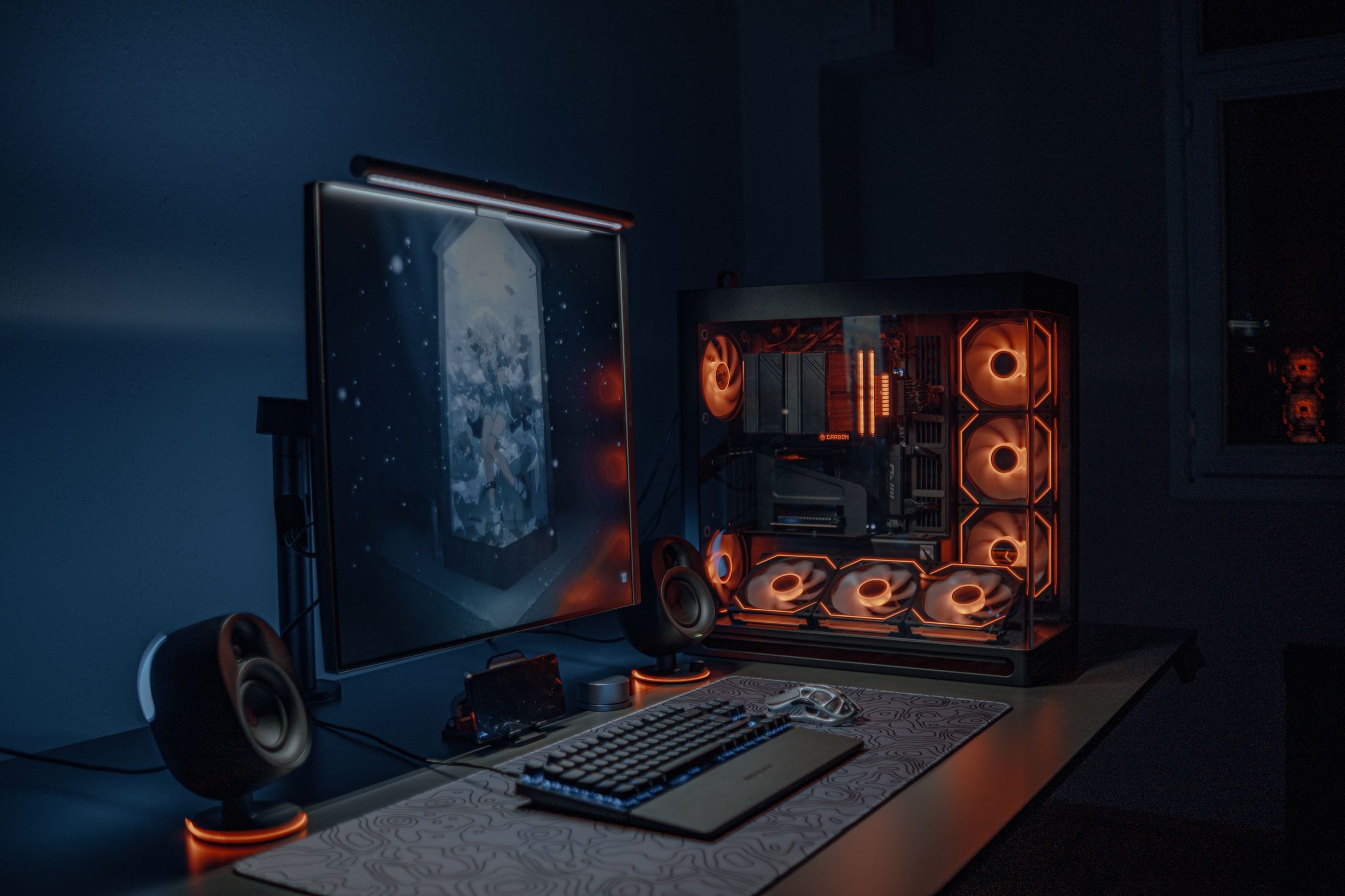 Sleek gaming PC setup with LED lighting, monitor and keyboard